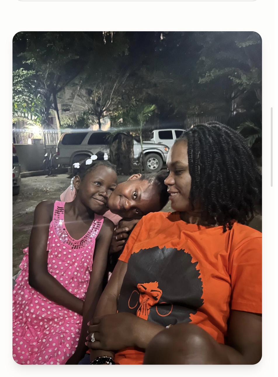 Angie Moore with two children in Cap-Haïtien