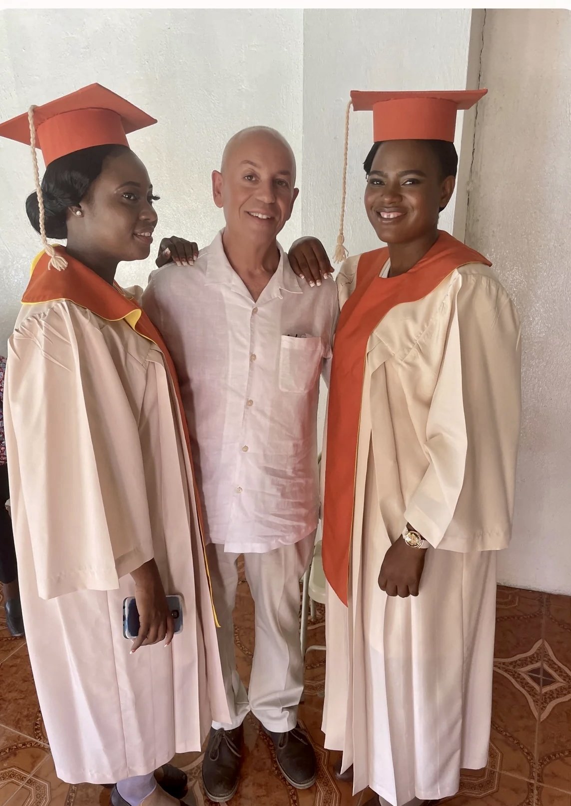 Darline, right, at her graduation with Randy Moore in Cap-Haïtien