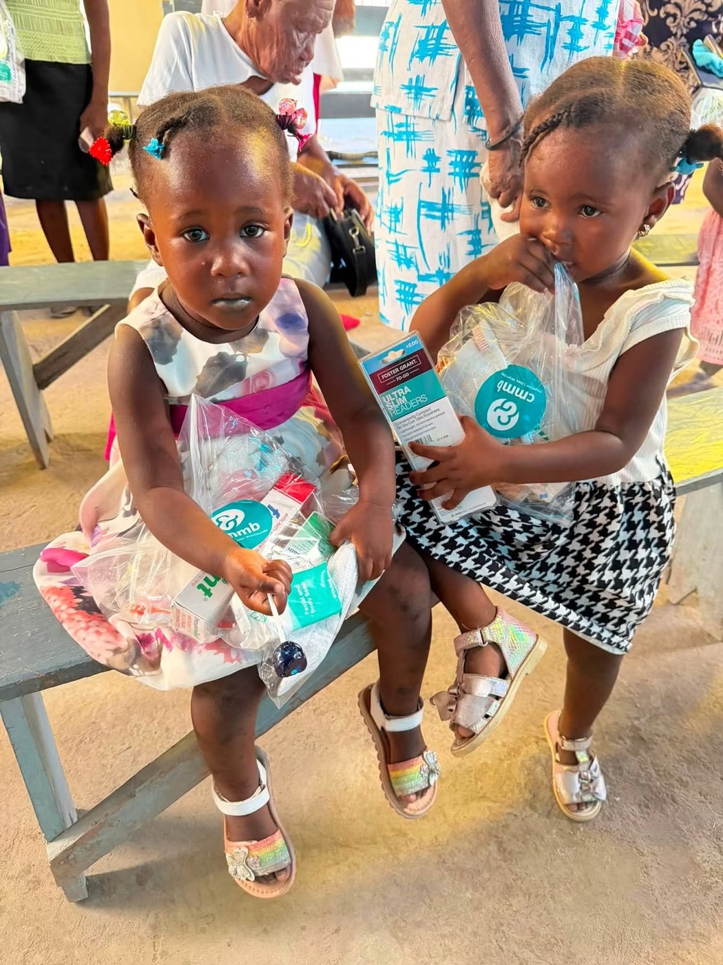 Students in Cap-Haïtien holding up new notebooks and school supplies